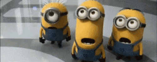 three minions are standing next to each other with their mouths open and looking surprised .