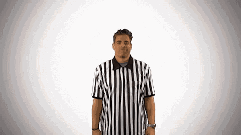 a man wearing a black and white striped referee shirt