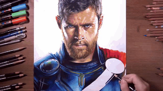a drawing of a man with a beard is on a table with colored pencils