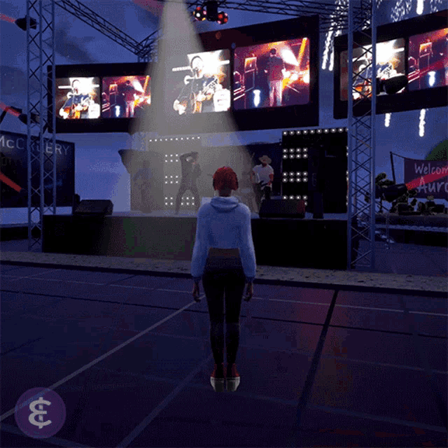 a woman standing in front of a stage with a sign that says welcome auro