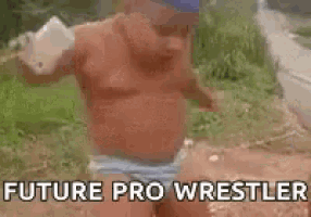 a man without a shirt is holding a bottle of water in his hand .