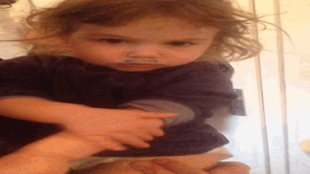 a little girl with a blue sticker on her nose that says ' i love you '