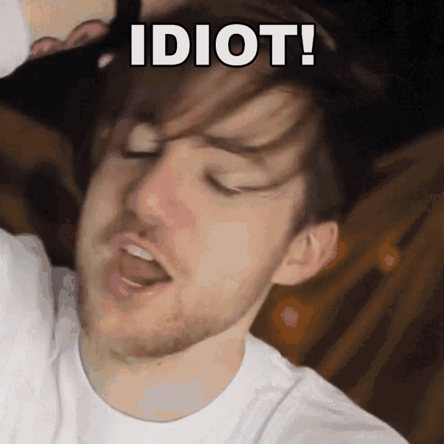 a man with a beard is making a funny face with the words idiot on his face