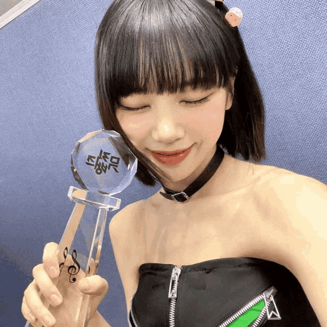 a woman is holding a trophy that says ' s ' on it