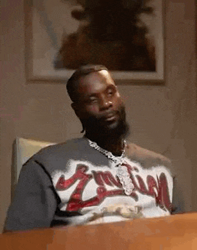 a man with a beard is sitting at a table .
