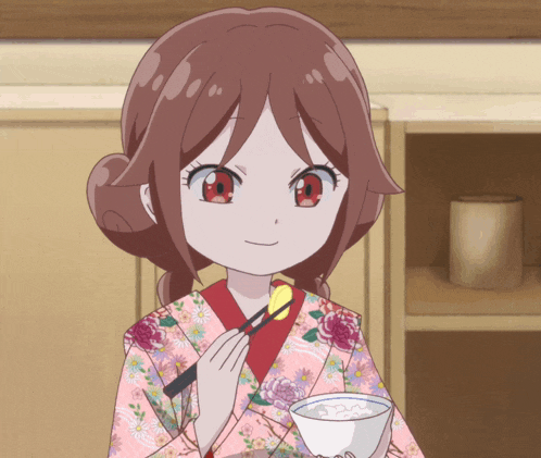 a girl in a kimono is holding a bowl of food with chopsticks