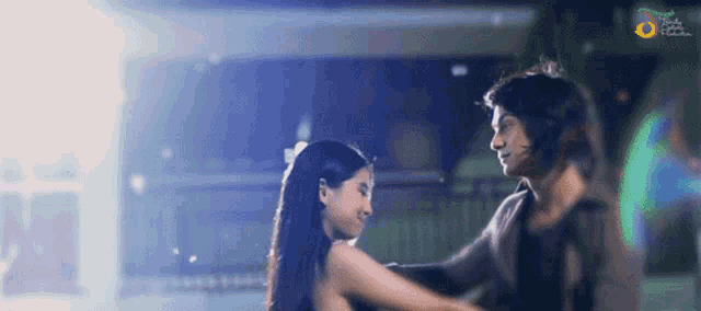a man and a woman are dancing in front of a sign that says ' apollo '