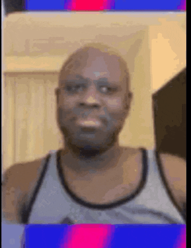 a bald man wearing a tank top and glasses is making a funny face .