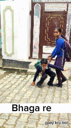 a boy and a girl are playing on a brick sidewalk with the words bhaga re gpay kru bol on the bottom