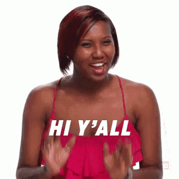 a woman in a pink dress is clapping her hands and saying hi y 'all .