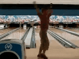 a man is playing bowling in a bowling alley with a bowling ball that says ' w ' on it