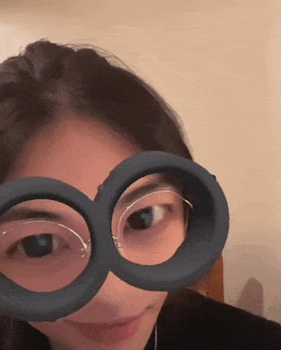 a woman wearing a pair of glasses that look like infinity
