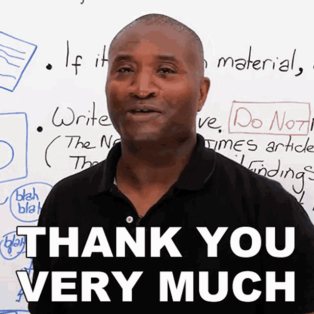 a man stands in front of a white board with the words thank you very much