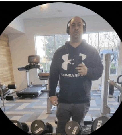 a man wearing a black under armour hoodie takes a selfie