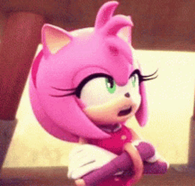 amy rose from the video game sonic the hedgehog is sitting on a bench .