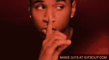 a man is making a shhh gesture with his finger to his mouth .