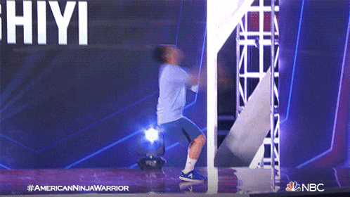 a nbc ad for american ninja warrior shows a man jumping through a hole