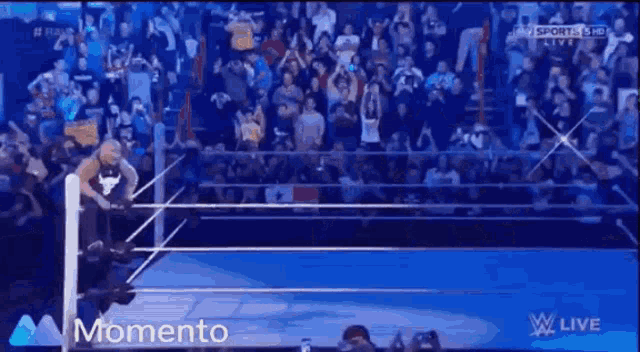 a man in a wrestling ring with the word momento on the bottom right