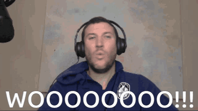 a man wearing headphones and a blue sweatshirt says wooooo