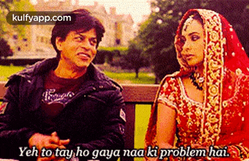 a man and a woman are sitting on a bench and the man is saying yeh to tay ho gaya naa ki problem hai ..