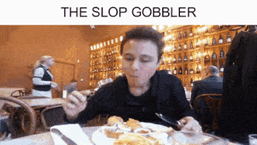 a man is sitting at a table in a restaurant eating food with the caption the slop gobbler