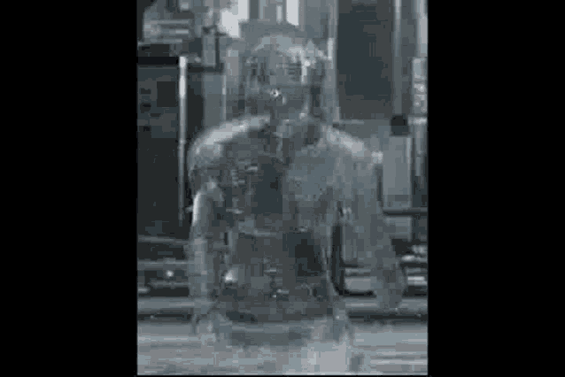 a man covered in ice is standing in a city street .