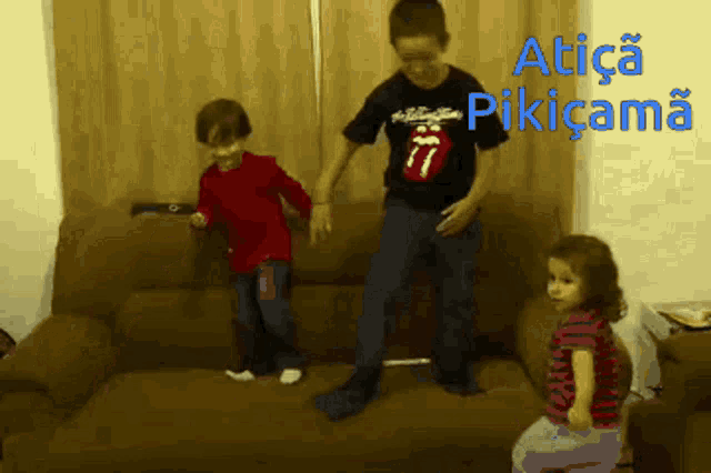 a boy wearing a rolling stones shirt is dancing with a girl