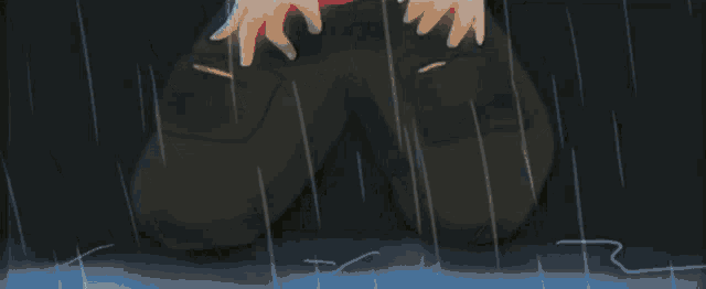 a close up of a person 's hand holding a sword in a dark room .
