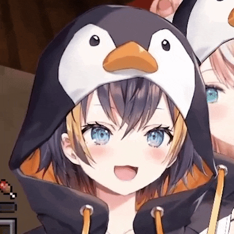 a close up of a girl wearing a penguin hat and hoodie .