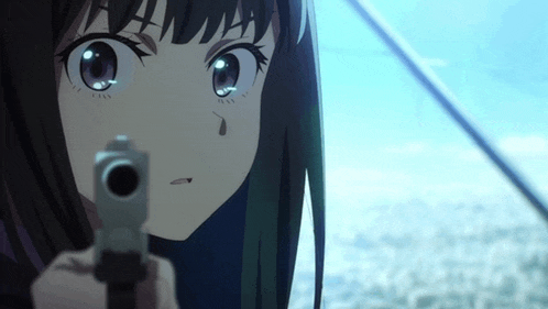 a close up of a girl pointing a gun at something