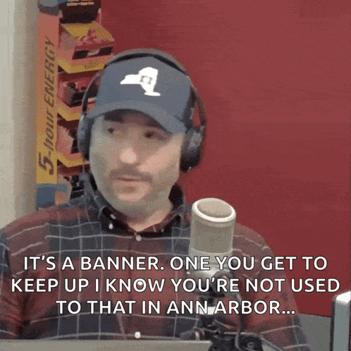 a man wearing headphones and a hat says it 's a banner one you get to keep up