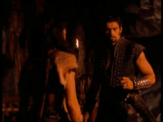 a man and a woman are standing next to each other and the man is saying " ok "
