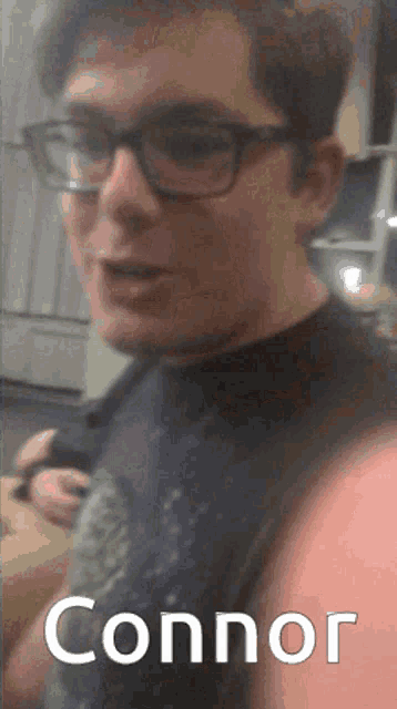 a man with glasses and the name connor on his face