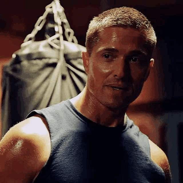 a man is standing in front of a punching bag .