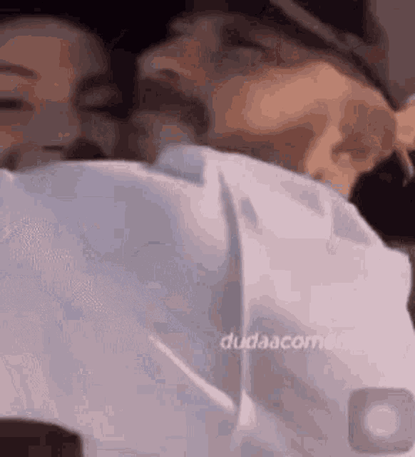 a man and a woman are kissing each other .
