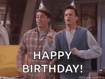 a couple of men wearing party hats are standing next to each other and saying `` happy birthday ! ''