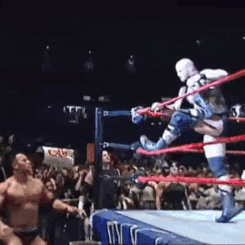 a man in a wrestling ring with a sign that says ' cam ' on it