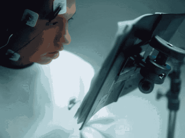 a person wearing a white nike shirt is looking at a monitor