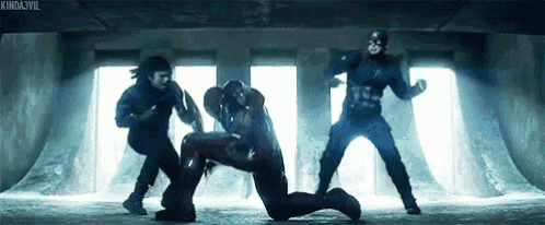 a group of men are standing next to each other in a dark room and fighting .