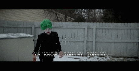 a person with a green mohawk is standing in front of a fence with the words " valentine 's day today " on the screen