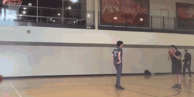 a basketball court with a sign that says confidence in the background