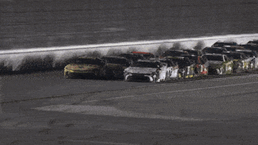 a group of race cars are lined up on a race track
