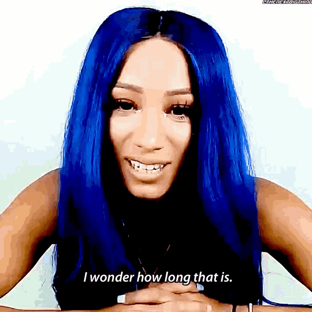 a woman with blue hair is smiling and saying i wonder how long that is