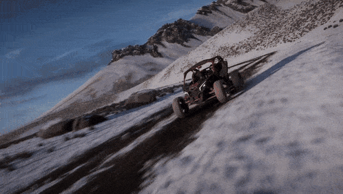 a buggy is driving down a snow covered road