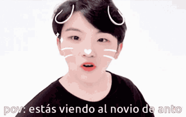 a young man wearing a cat face mask says " pov : estas viendo al novio de anto " .