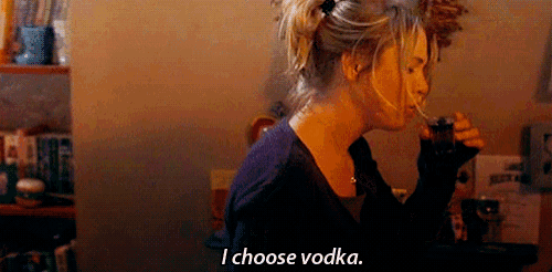 a woman is drinking a glass of vodka and says " i choose vodka "