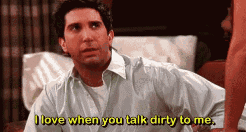 a man in a white shirt is sitting on a couch and saying `` i love when you talk dirty to me '' .