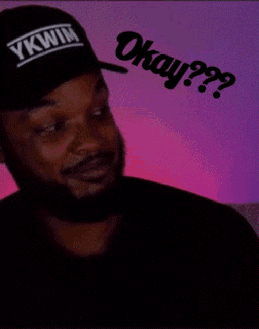 a man wearing a hat that says ykwim okay