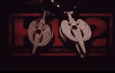 a couple of necklaces are sitting in front of a red sign that says ' views '