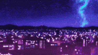 a girl standing on top of a building looking at a city at night